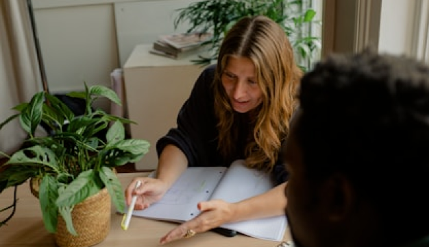 Woman creating educational video content with notes and laptop